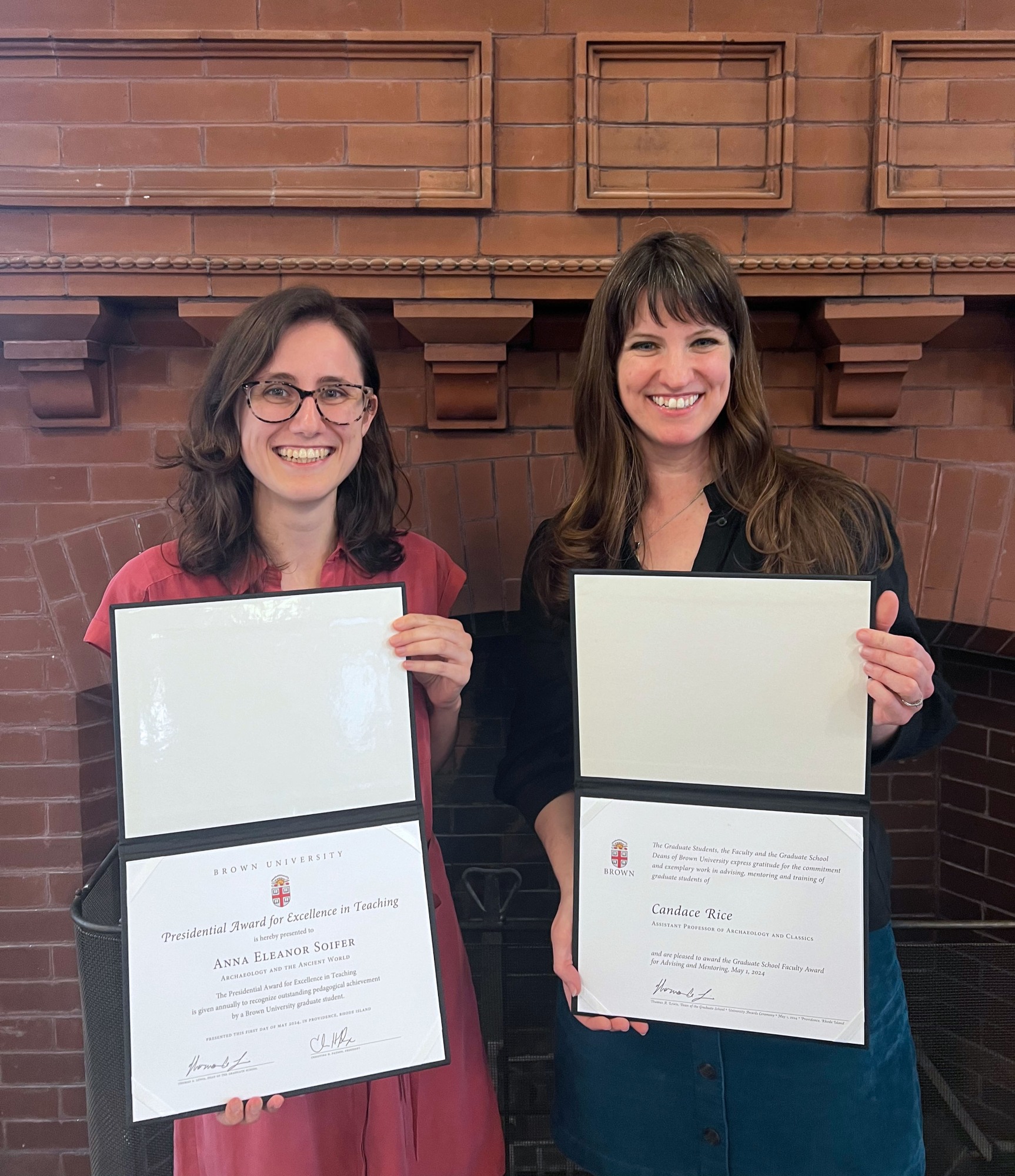 Anna Soifer and Candace Rice hold awards they received from the Graduate School